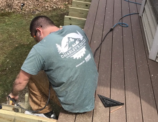 Charley's Decks craftsman installing TimberTech Advanced PVC decking on site