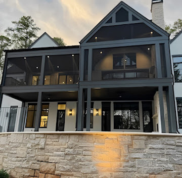 Two-story covered deck lit at dusk