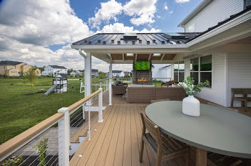 Covered deck pavilion with outdoor dining and lounge seating, built by Charley's Decks