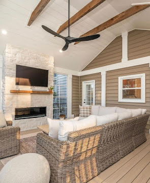 Covered deck with stone fireplace and mounted TV